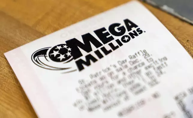 A Mega Millions lottery ticket is displayed at a store on Thursday, Dec. 26, 2024, in Tigard, Ore. (AP Photo/Jenny Kane)