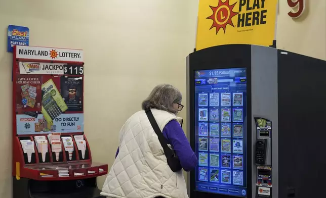 A person makes their lottery ticket selections on a self-serve terminal inside a gas station ahead of Friday's Mega Millions drawing of $1.15 billion, Thursday, Dec. 26, 2024, in Baltimore. (AP Photo/Stephanie Scarbrough)