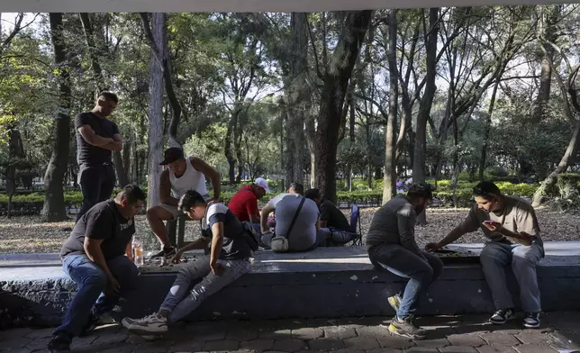 Participants play Poleana, a board game invented in prison, during a tournament in Mexico City, Sunday, Nov. 17, 2024. (AP Photo/Ginnette Riquelme)