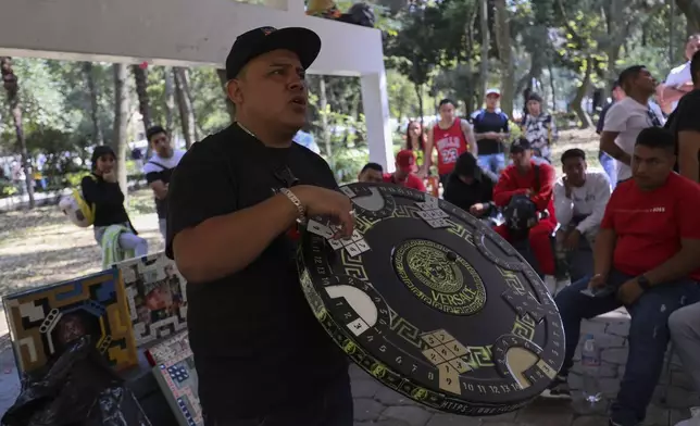 Jonathan Rulleri, the founder of Poleanas Canada Frogs, holds up a poleana board, a game he invented in prison, to be raffled off before the start of a tournament in Mexico City, Sunday, Nov. 17, 2024. (AP Photo/Ginnette Riquelme)