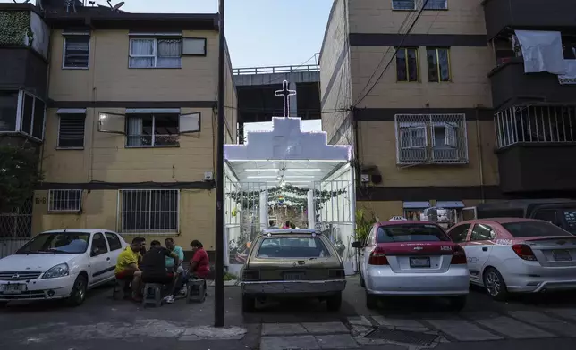 Residents play Poleana, a board game invented in prison in Mexico City, Sunday, Dec. 8, 2024. (AP Photo/Ginnette Riquelme)