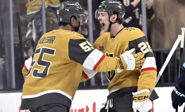 Vegas Golden Knights right wing Keegan Kolesar (55) and right wing Cole Schwindt (22) celebrate after Kolesar's goal against the Seattle Kraken during the first period of an NHL hockey game Saturday, Dec. 21, 2024, in Las Vegas. (AP Photo/David Becker)