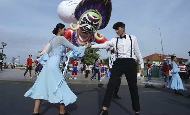 Cambodian dancers perform during the "Celebrating Cambodia" event as part of the New Year's Eve in front of Royal Palace in Phnom Penh, Cambodia, Tuesday Dec. 31, 2024. (AP Photo/Heng Sinith)