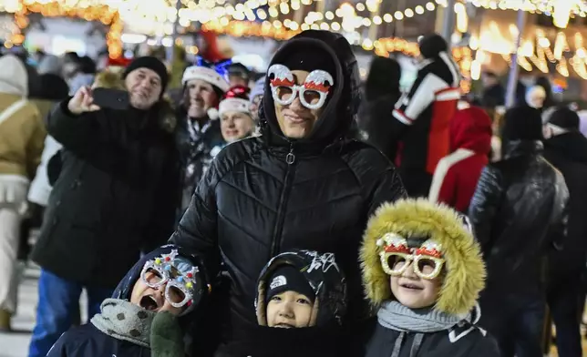 People gather in the center of the Russian far east port of Vladivostok, Russia, Tuesday, Dec. 31, 2024, to celebrate the new year. (AP Photo)