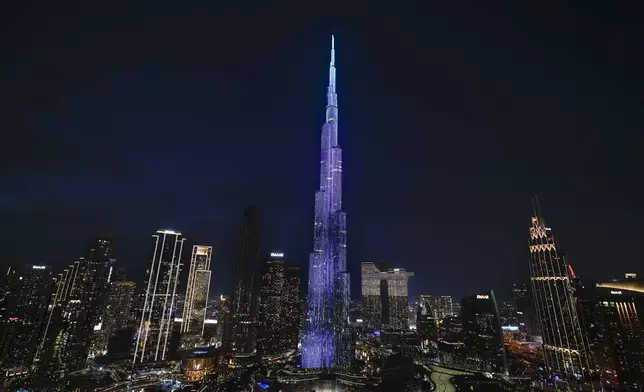 Lights illuminate Burj Khalifa, the world's tallest building, ahead of New Year's Eve celebration, in Dubai, United Arab Emirates, Tuesday, Dec. 31, 2024. (AP Photo/Altaf Qadri)