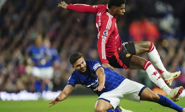 Ipswich Town's Sam Morsy, bottom, tackles Manchester United's Marcus Rashford during the English Premier League soccer match between Ipswich Town and Manchester United at Portman Road stadium in Ipswich, England, Sunday, Nov. 24, 2024. (AP Photo/Dave Shopland)