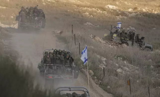 Israeli soldiers cross the security fence moving towards the so-called Alpha Line that separates the Israeli-annexed Golan Heights from Syria, in the town of Majdal Shams, Sunday, Dec. 15, 2024. (AP Photo/Matias Delacroix)