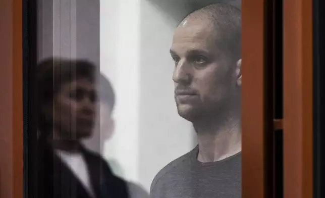 FILE - Wall Street Journal reporter Evan Gershkovich listens to the verdict against him in a glass cage in a courtroom in Yekaterinburg, Russia, on July 19, 2024. (AP Photo/Dmitri Lovetsky, File)