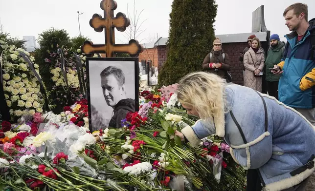 FILE - A woman lays flowers at the grave of Russian opposition leader Alexei Navalny at the Borisovskoye Cemetery in Moscow, on March 2, 2024. (AP Photo, File)