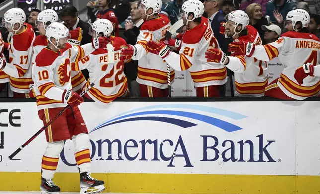 Calgary Flames center Jonathan Huberdeau (10) celebrates after his goal against the San Jose Sharks during the first period of an NHL hockey game Saturday, Dec. 28, 2024, in San Jose, Calif. (AP Photo/Eakin Howard)