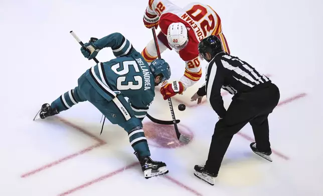 San Jose Sharks center Ty Dellandrea (53) and Calgary Flames center Blake Coleman (20) face off during the third period of an NHL hockey game Saturday, Dec. 28, 2024, in San Jose, Calif. (AP Photo/Eakin Howard)