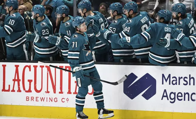 San Jose Sharks center Macklin Celebrini (71) celebrates his goal against the Calgary Flames during the second period of an NHL hockey game Saturday, Dec. 28, 2024, in San Jose, Calif. (AP Photo/Eakin Howard)