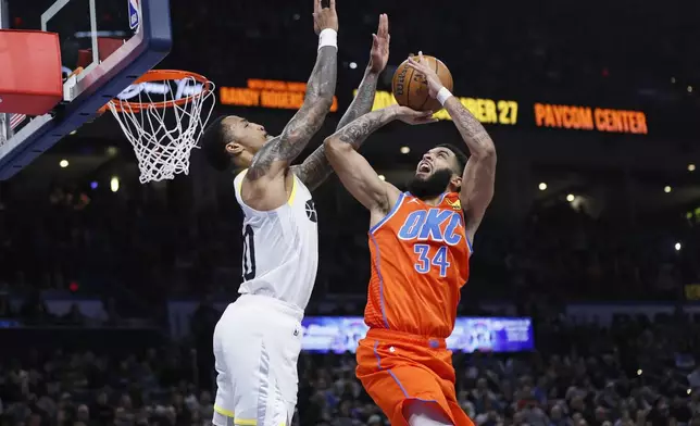 Oklahoma City Thunder forward Kenrich Williams (34) prepares to shoot against Utah Jazz forward John Collins, left, during the first half of an Emirates NBA Cup basketball game, Tuesday, Dec. 3, 2024, in Oklahoma City. (AP Photo/Nate Billings)