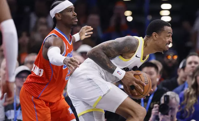 Utah Jazz forward John Collins, right, drives in front of Oklahoma City Thunder guard Shai Gilgeous-Alexander, left, during the first half of an Emirates NBA Cup basketball game, Tuesday, Dec. 3, 2024, in Oklahoma City. (AP Photo/Nate Billings)