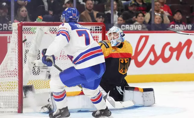 USA forward Brodie Ziemer (74) gets the puck past to score on Germany goaltender Nico Pertuch (1) during third period IIHF World Junior Hockey Championship preliminary round action in Ottawa on Thursday, Dec. 26, 2024. (Sean Kilpatrick/The Canadian Press via AP)