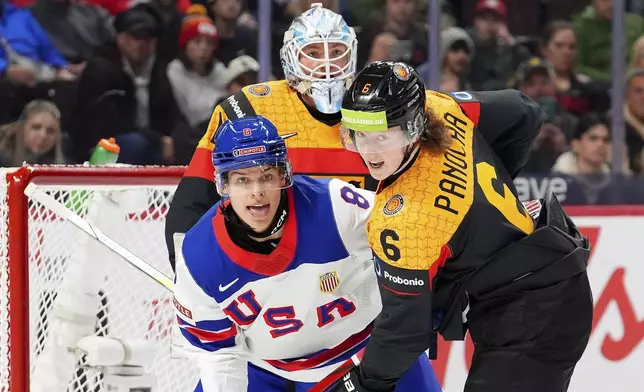 USA forward Brandon Svoboda (8), Germany defenceman Norwin Panocha (6) and teammate Nico Pertuch (1) look towards the puck during first period IIHF World Junior Hockey Championship preliminary round action in Ottawa on Thursday, Dec. 26, 2024. (Sean Kilpatrick/The Canadian Press via AP)