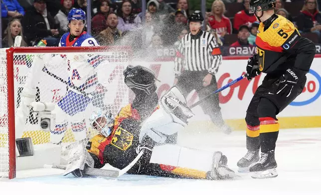 Germany goaltender Nico Pertuch (1) makes a save during first period IIHF World Junior Hockey Championship preliminary round action against the United States, in Ottawa on Thursday, Dec. 26, 2024. (Sean Kilpatrick/The Canadian Press via AP)