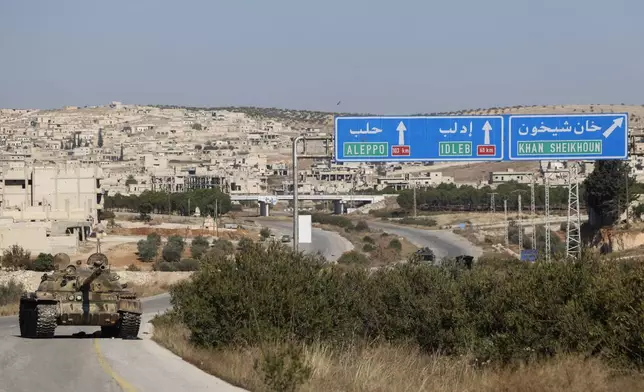 An abandoned Syrian army armoured vehicle sits on a highway in the outskirts of in Khan Sheikhoun, southwest of Aleppo, Sunday, Dec. 1, 2024. Syrian opposition insurgency launched a campaign on Wednesday with a two-pronged attack on Aleppo and the countryside around Idlib.(AP Photo/Ghaith Alsayed)