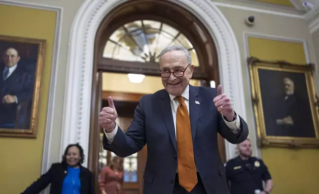 Senate Majority Leader Chuck Schumer, D-N.Y., celebrates as the Senate begins voting on the government funding bill just in time to meet the midnight deadline, at the Capitol in Washington, Friday, Dec. 20, 2024. (AP Photo/J. Scott Applewhite)