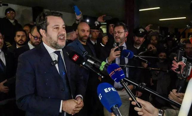 Italy's vice Premier Matteo Salvini speaks to journalists as he leaves a Palermo's law court in Sicily, Italy, Friday, Dec. 20, 2024, after he was acquitted in a first instance trial where he was accused of blocking for 19 days the disembarkation of 147 people, including minors, rescued at sea by the NGO Open Arms in August 2019.(AP Photo/Salvatore Cavalli)