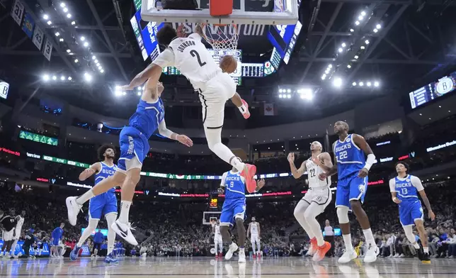 Brooklyn Nets' Cameron Johnson dunks during the first half of an NBA basketball game against the Milwaukee Bucks Thursday, Dec. 26, 2024, in Milwaukee. (AP Photo/Morry Gash)