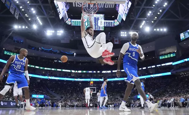 Brooklyn Nets' Ben Simmons dunks during the first half of an NBA basketball game against the Milwaukee Bucks Thursday, Dec. 26, 2024, in Milwaukee. (AP Photo/Morry Gash)