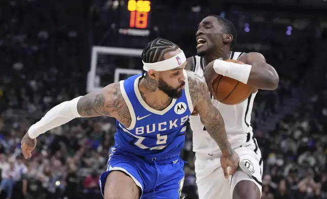 Brooklyn Nets' Shake Milton tries to get past Milwaukee Bucks' Gary Trent Jr. during the first half of an NBA basketball game Thursday, Dec. 26, 2024, in Milwaukee. (AP Photo/Morry Gash)