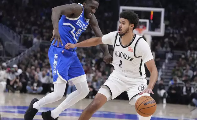 Brooklyn Nets' Cameron Johnson tries to get past Milwaukee Bucks' Taurean Prince during the first half of an NBA basketball game Thursday, Dec. 26, 2024, in Milwaukee. (AP Photo/Morry Gash)