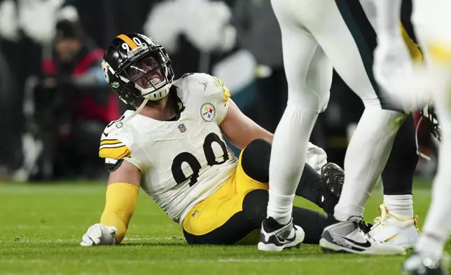 Pittsburgh Steelers linebacker T.J. Watt (90) sits on the field after an injury during the second half of an NFL football game against the Philadelphia Eagles on Sunday, Dec. 15, 2024, in Philadelphia. (AP Photo/Derik Hamilton)