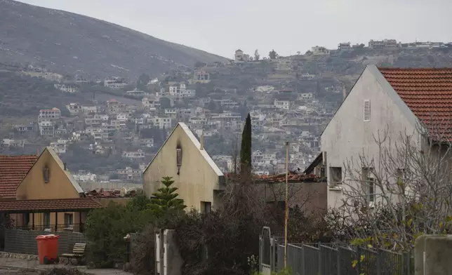 CORRECTS NAME OF LEBANESE VILLAGE .- Backdropped by the southern Lebanese village of El Adeise, houses damaged by Hezbollah rockets attacks are seen in Metula, Israel's northernmost town, Wednesday Dec. 4, 2024. 2024. (AP Photo/Ohad Zwigenberg)