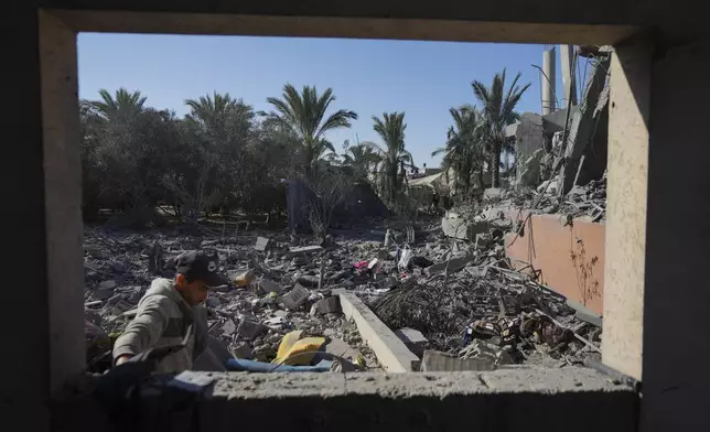 A Palestinian inspects the rubble of a destroyed building following an overnight Israeli strike in Deir al-Balah, Gaza Strip, Wednesday, Dec. 4, 2024. (AP Photo/Abdel Kareem Hana)