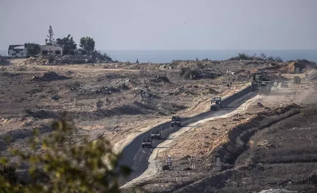 Israeli armoured vehicles move on in an area at the Israeli-Gaza border, seen from southern Israel, Tuesday, Dec. 3, 2024. (AP Photo/Tsafrir Abayov)