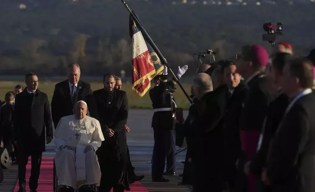 Pope Francis arrives at Ajaccio International Airport on the occasion of his one-day visit in the French island of Corsica, Sunday, Dec. 15, 2024. (AP Photo/Alessandra Tarantino)