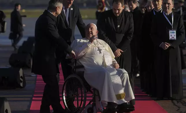 Pope Francis arrives at Ajaccio International Airport on the occasion of his one-day visit in the French island of Corsica, Sunday, Dec. 15, 2024. (AP Photo/Alessandra Tarantino)