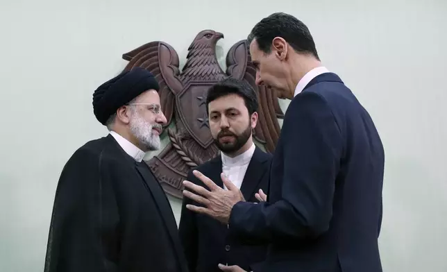 FILE - Syrian President Bashar Assad, right, speaks with Iranian President Ebrahim Raisi, left, in Damascus, Syria, May 3, 2023. (AP Photo/Omar Sanadiki, File)