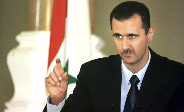 FILE - Syrian President Bashar Assad speaks at a press conference in Cairo, Oct. 2, 2000. (AP Photo/Amr Nabil, File)