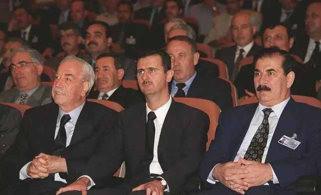 FILE - Bashar Assad, second right, is seen during the closing session of the ruling Baath party congress in Damascus, Syria, June 20, 2000. (SANA via AP, File)