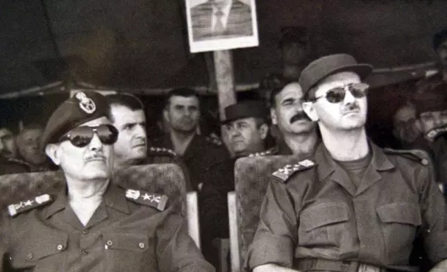 FILE - President-elect Lt. Gen. Bashar al Assad, right, attends military training games with Ali Aslan, Chief of Staff of the Syrian army, July 12, 2000, in Syria. (SANA via AP, File)