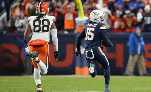 Denver Broncos linebacker Nik Bonitto (15) picks off a pass intended for Cleveland Browns tight end Jordan Akins (88) and returns the ball 71-yards for a touchdown during the first half of an NFL football game, Monday, Dec. 2, 2024, in Denver. (AP Photo/Jack Dempsey)