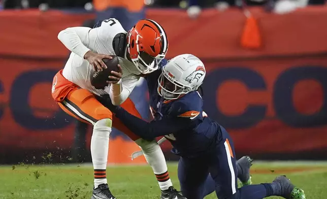 Cleveland Browns quarterback Jameis Winston (5) is sacked by Denver Broncos linebacker Nik Bonitto during the second half of an NFL football game, Monday, Dec. 2, 2024, in Denver. (AP Photo/David Zalubowski)