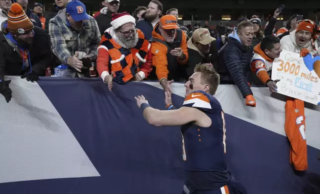 Denver Broncos quarterback Bo Nix celebrates with fans following an NFL football game against the Cleveland Browns, Monday, Dec. 2, 2024, in Denver. (AP Photo/Jack Dempsey)