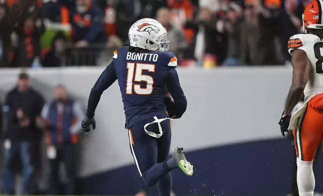 Denver Broncos linebacker Nik Bonitto (15) outruns Cleveland Browns tight end Jordan Akins for a 71-yard interception return for a touchdown during the first half of an NFL football game, Monday, Dec. 2, 2024, in Denver. (AP Photo/David Zalubowski)