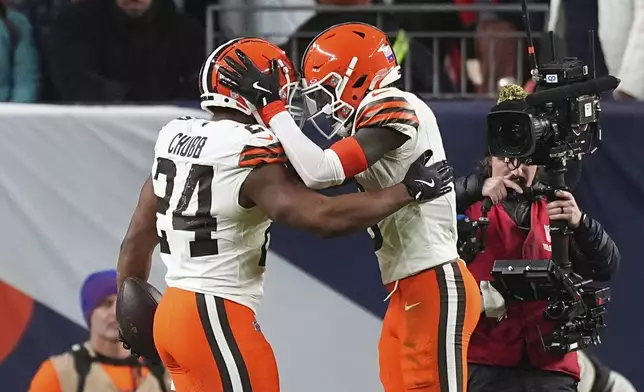 Cleveland Browns running back Nick Chubb (24) celebrates his 5-yard reception for a touchdown with wide receiver Jerry Jeudy during the second half of an NFL football game against the Denver Broncos, Monday, Dec. 2, 2024, in Denver. (AP Photo/David Zalubowski)