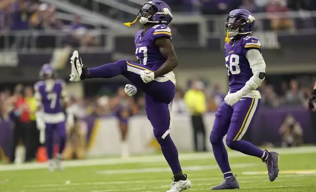 Minnesota Vikings linebacker Jamin Davis (57) celebrates after sacking Atlanta Falcons quarterback Kirk Cousins during the first half of an NFL football game, Sunday, Dec. 8, 2024, in Minneapolis. (AP Photo/Abbie Parr)