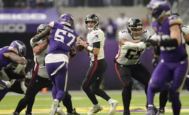 Atlanta Falcons quarterback Kirk Cousins (18) looks to pass during the first half of an NFL football game against the Minnesota Vikings, Sunday, Dec. 8, 2024, in Minneapolis. (AP Photo/Abbie Parr)