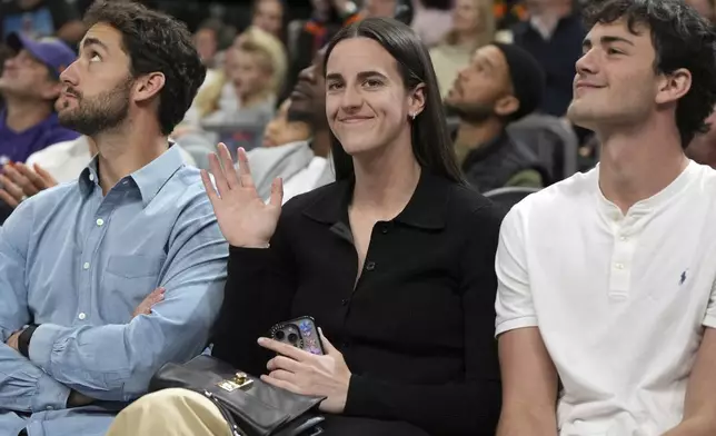 WNBA star Caitlin Clark is introduced to the fans during the first half of an NBA basketball game between the Phoenix Suns and the Golden State Warriors, Saturday, Nov. 30, 2024, in Phoenix. (AP Photo/Rick Scuteri)