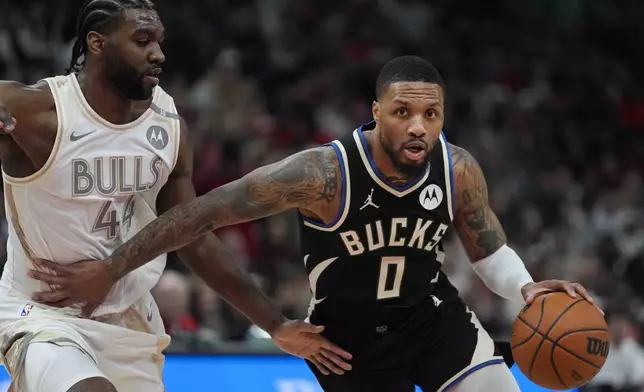 Chicago Bulls forward Patrick Williams, left, guards Milwaukee Bucks guard Damian Lillard during the first half of an NBA basketball game Saturday, Dec. 28, 2024, in Chicago. (AP Photo/Erin Hooley)