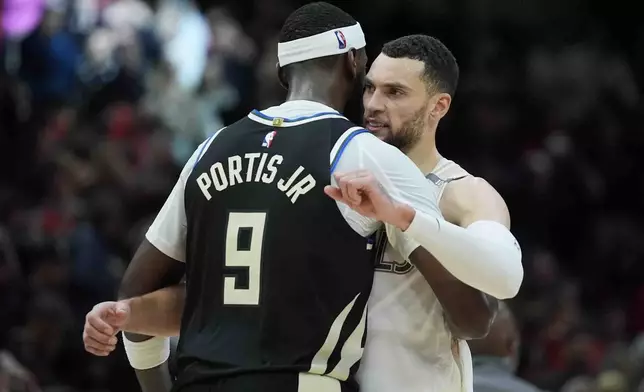 Milwaukee Bucks forward Bobby Portis, left, hugs Chicago Bulls guard Zach LaVine, right, after an NBA basketball game Saturday, Dec. 28, 2024, in Chicago. (AP Photo/Erin Hooley)