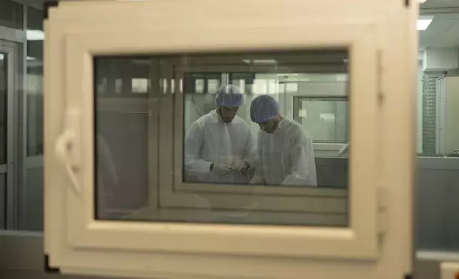 Employees work in Moldiag, a biotechnology startup, while producing mpox tests, in Tamesna, Morocco, Thursday, Nov. 28, 2024. (AP Photo/Mosa'ab Elshamy)