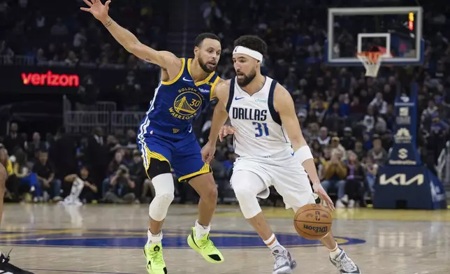 Golden State Warriors guard Stephen Curry (30) defends against Dallas Mavericks guard Klay Thompson (31) during the first half of an NBA basketball game Sunday, Dec. 15, 2024, in San Francisco. (AP Photo/Benjamin Fanjoy)